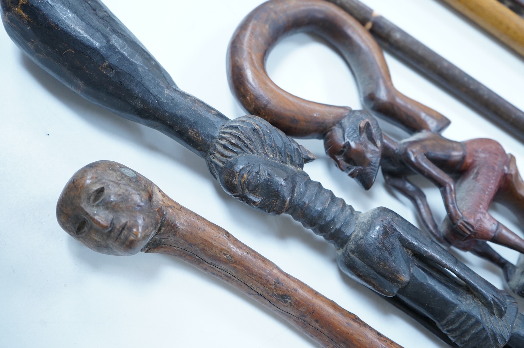 A collection of African and other walking sticks and walking canes - ebonised cane 105 cm long